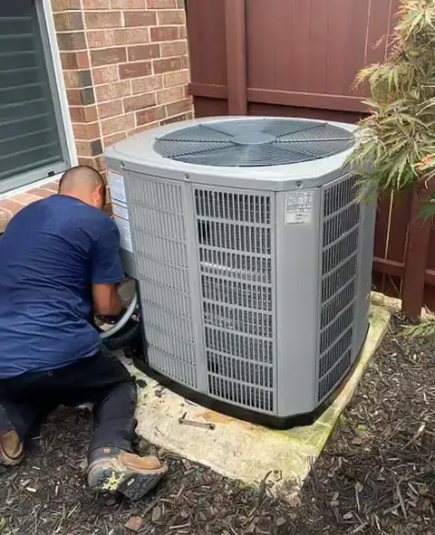 JRAC Cooling & Heating Services works on a customer's air conditioning unit in Garland, TX.