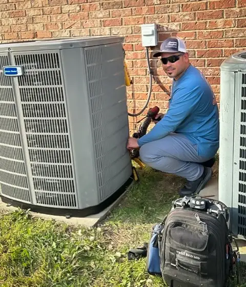 Luis, owner of JRAC Cooling & Heating, diagnoses and repairs an HVAC problem for a client.