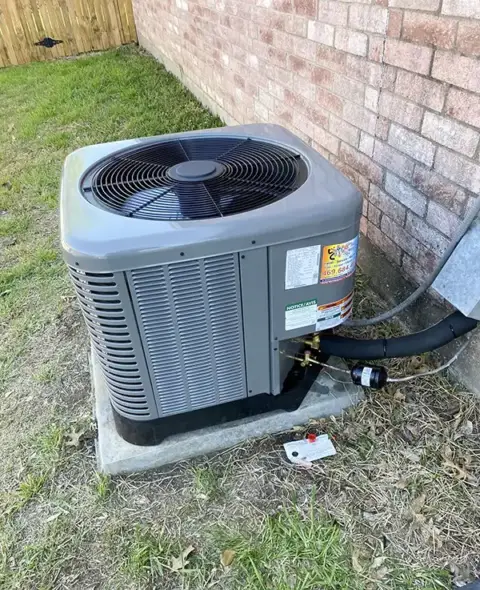 A small outside air conditioning unit installed by JRAC Cooling & Heating.